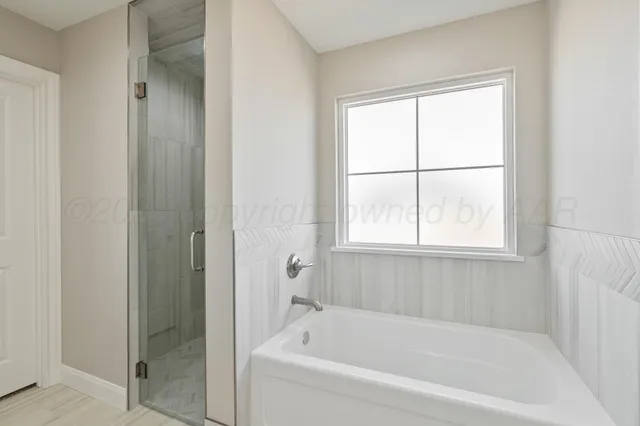 a bathroom with a bathtub and shower