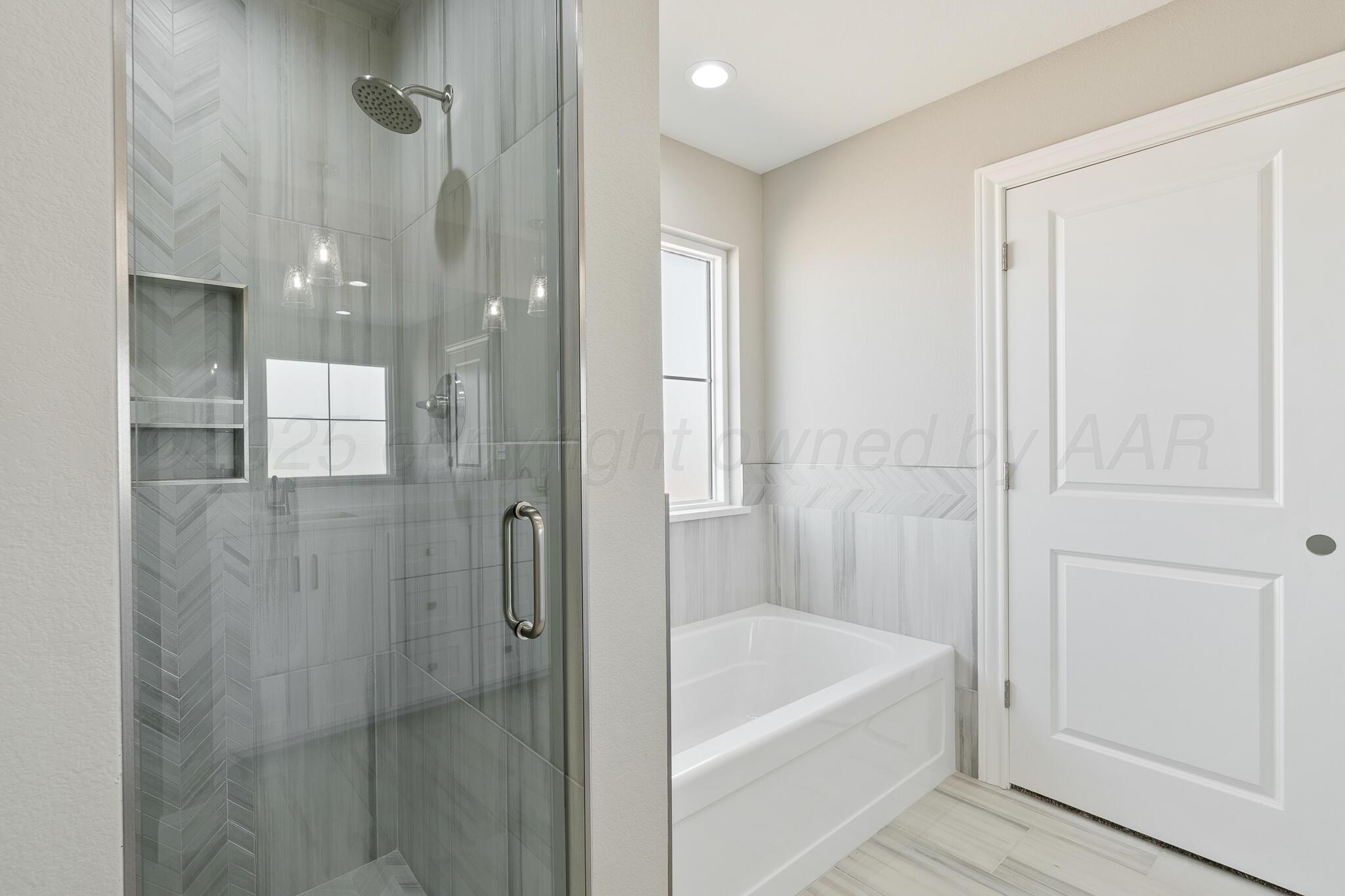 3551 Whitetail Springs Road Amarillo, TX 79119 - Photo 26 of 33 a bathroom with a bathtub and shower