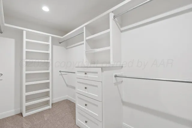an empty room with ceiling fan and window