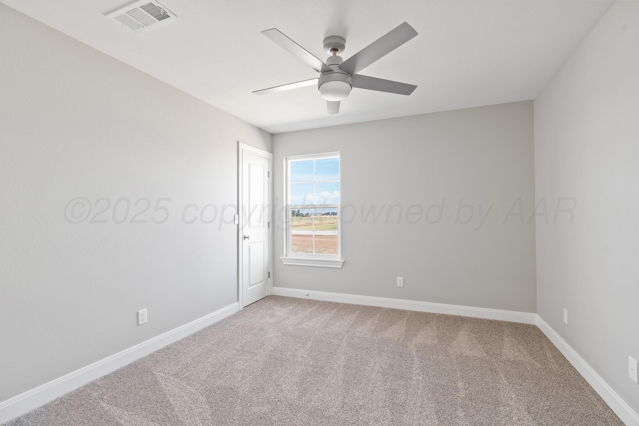 3551 Whitetail Springs Road Amarillo, TX 79119 - Photo 30 of 33 an empty room with a window and a fan