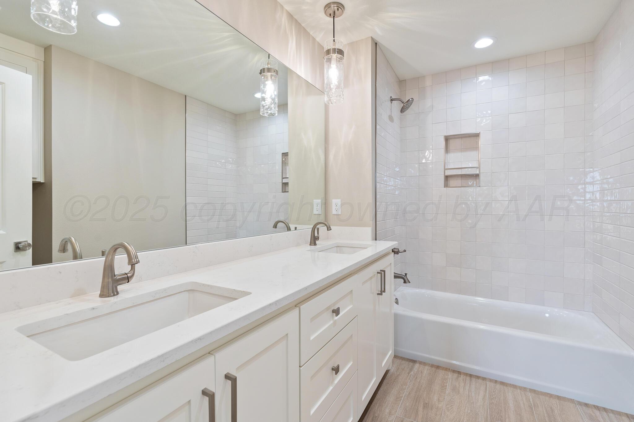 3551 Whitetail Springs Road Amarillo, TX 79119 - Photo 31 of 33 a bathroom with a tub sink and mirror