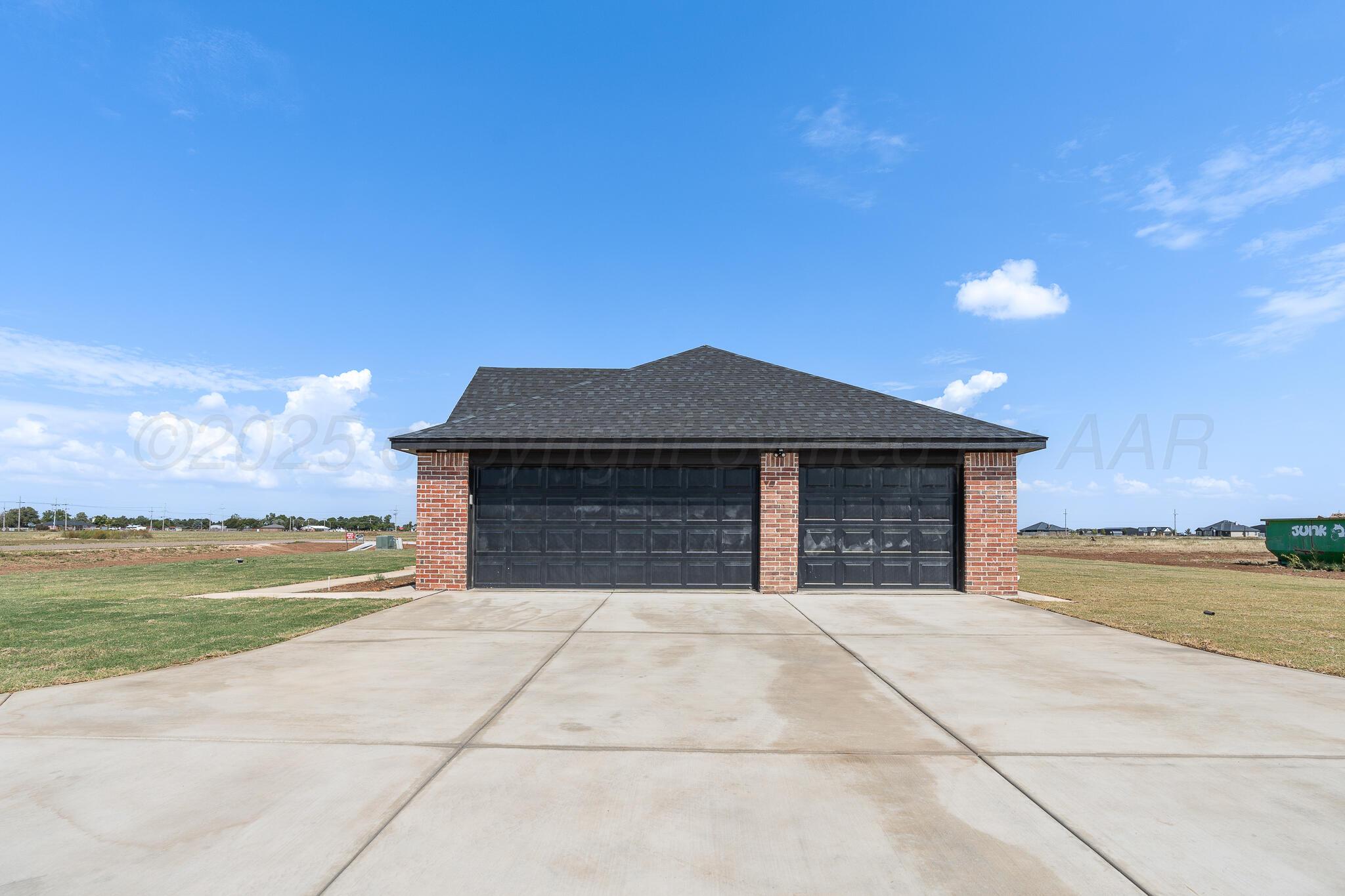 3551 Whitetail Springs Road Amarillo, TX 79119 - Photo 4 of 33 a front view of a house with a yard and a garage