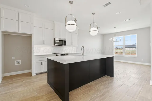 a kitchen with a sink and cabinets