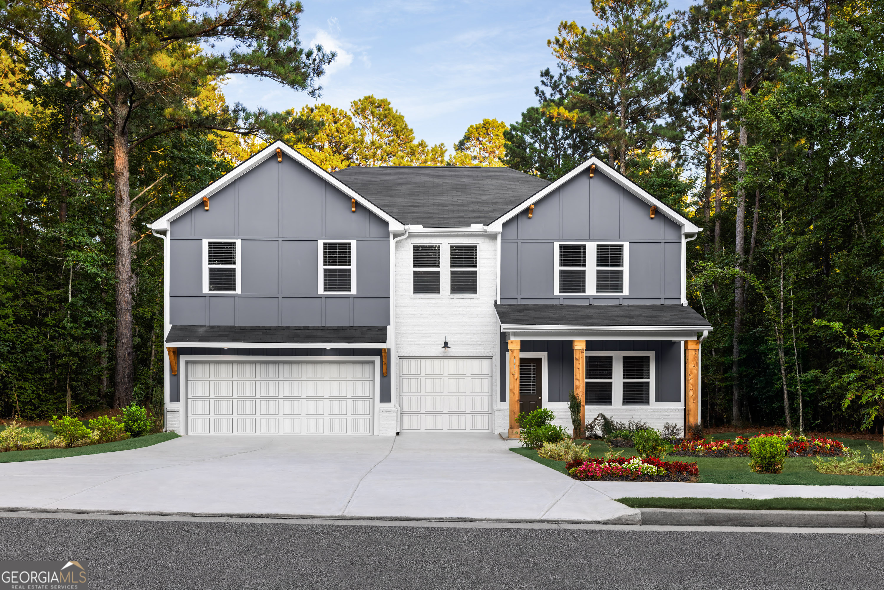 129 Southeast Honey Creek Road, Unit 4 Conyers, GA 30094 - Photo 2 of 21 a front view of a house with a yard and garage
