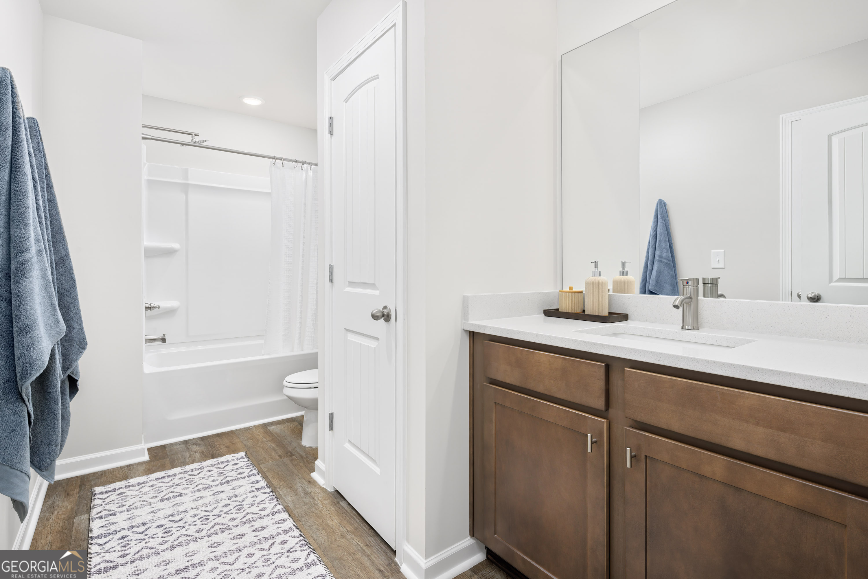 129 Southeast Honey Creek Road, Unit 4 Conyers, GA 30094 - Photo 10 of 21 a bathroom with a sink a toilet and shower