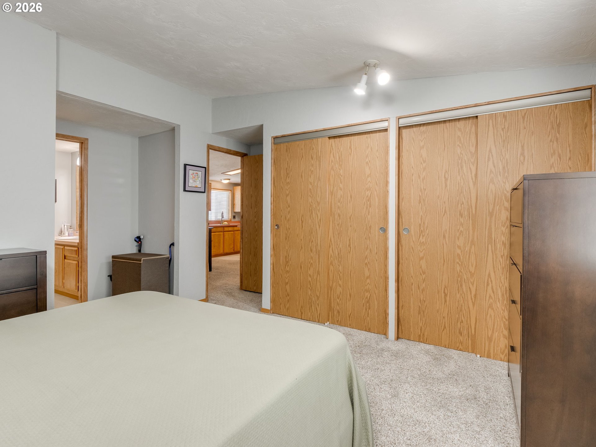 4730 Auburn Road Northeast, Unit 125 Salem, OR 97301 - Photo 22 of 36 a bedroom with a large bed and a chandelier