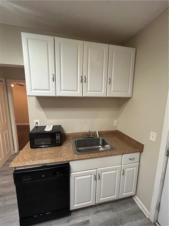 1182 Sims Street Southwest Atlanta, GA 30310 - Photo 22 of 35 a kitchen with granite countertop white cabinets and a stove top oven