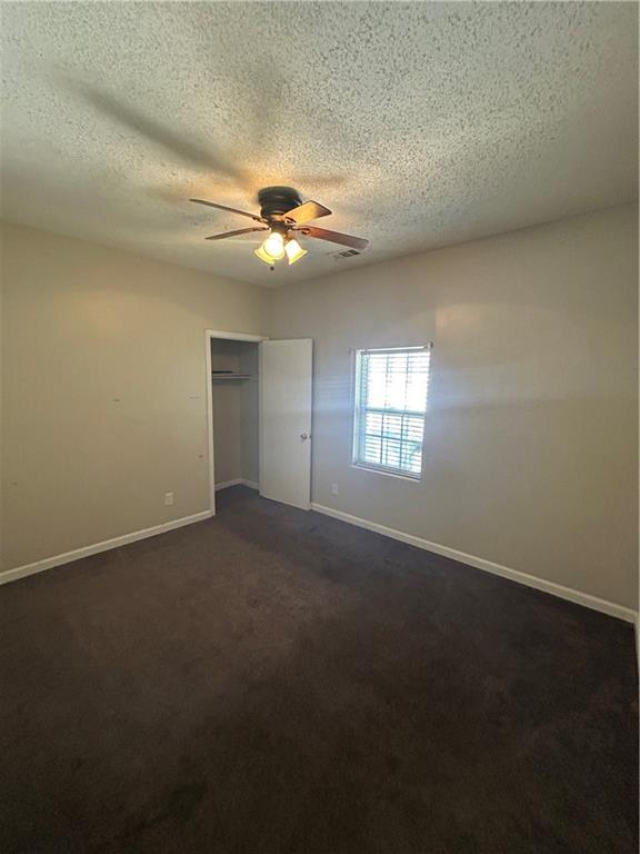 1182 Sims Street Southwest Atlanta, GA 30310 - Photo 28 of 35 an empty room with windows and fan chandelier