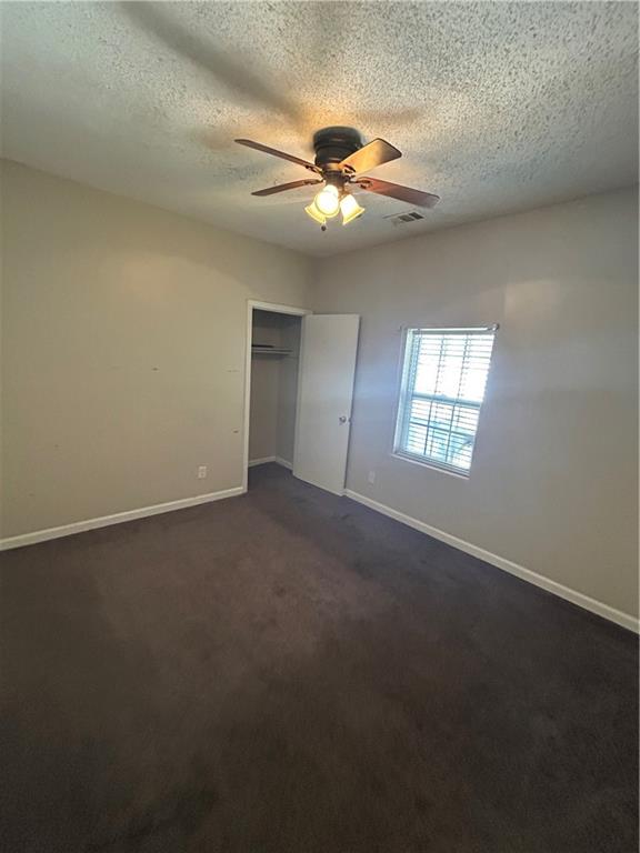 1182 Sims Street Southwest Atlanta, GA 30310 - Photo 30 of 35 an empty room with windows and fan chandelier fan