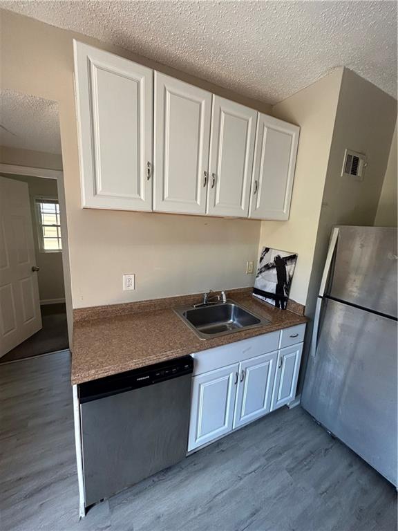 1182 Sims Street Southwest Atlanta, GA 30310 - Photo 5 of 35 a kitchen with granite countertop a sink a stove and cabinets