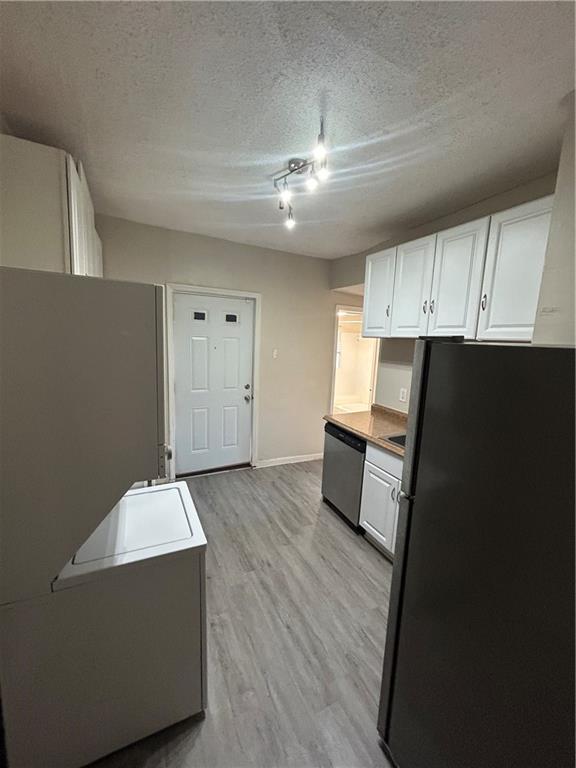 1182 Sims Street Southwest Atlanta, GA 30310 - Photo 7 of 35 a kitchen with granite countertop white cabinets and black appliances