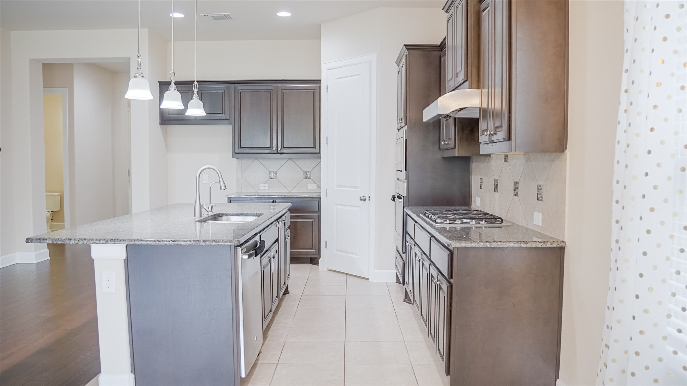 184 Fort Cobb Way Georgetown, TX 78628 - Photo 13 of 33 a kitchen with stainless steel appliances granite countertop a sink stove and refrigerator