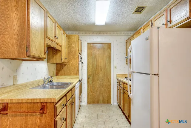 a bathroom with a granite countertop sink a mirror a shower and a bathtub