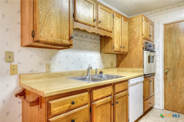 a kitchen with stainless steel appliances granite countertop a sink and cabinets