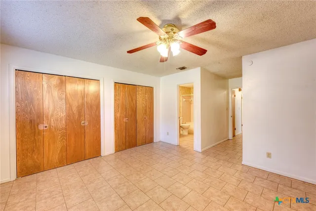 a view of a livingroom with a chandelier fan