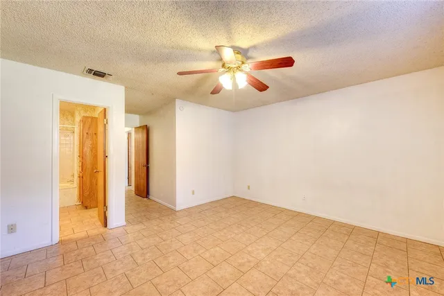 a view of a room with closet and ceiling fan