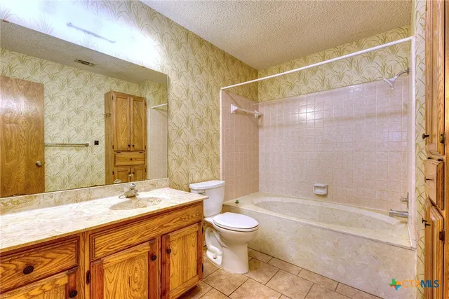 a bathroom with a double vanity sink toilet mirror and bathtub