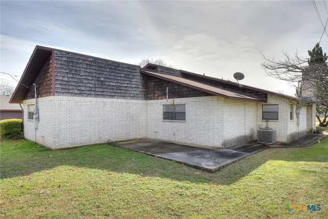 a backyard of a house with yard and barbeque oven