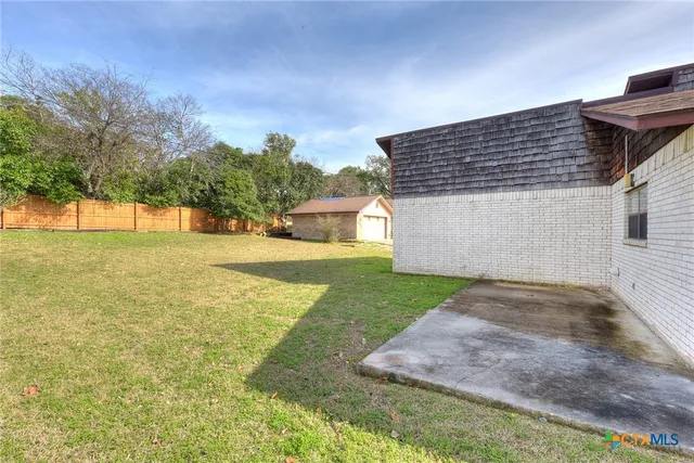 a backyard of a house with lots of green space
