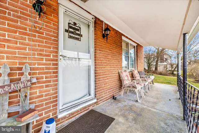 a balcony view with two chairs and a table