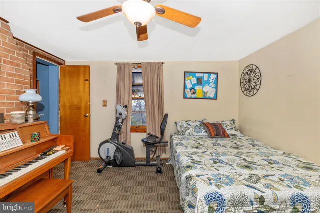 a living room with furniture and clock on the wall