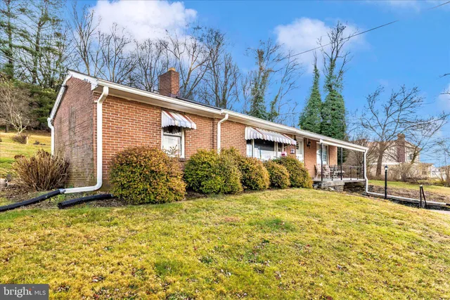 a view of a patio with lawn chairs under an umbrella