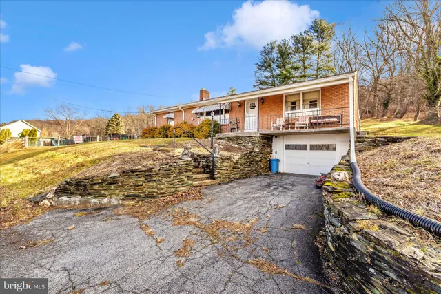 a backyard of a house with yard and outdoor seating
