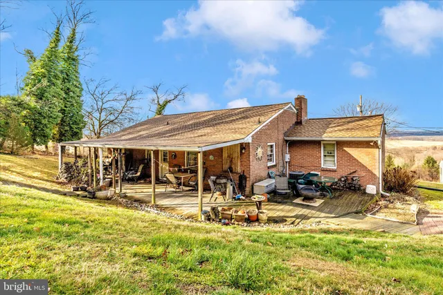 a view of a patio with table and chairs potted plants