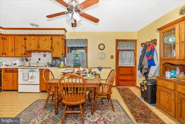 a dining room with a table and chairs