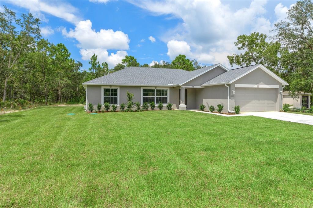 16375 Kakawi Road Brooksville, FL 34614 - Photo 2 of 30 a front view of a house with garden