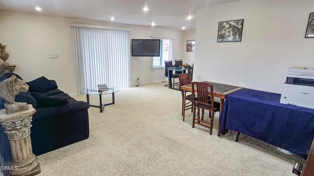 a bed sitting in a bedroom next to a window and a wooden floor