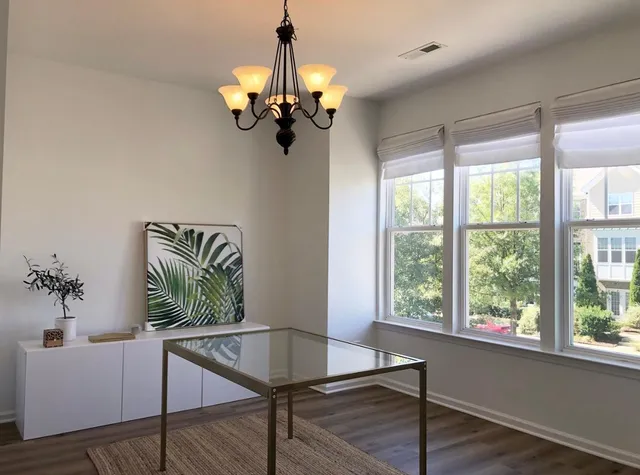 a view of a livingroom with furniture window and hardwood floor