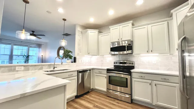 a kitchen with appliances cabinets and a sink