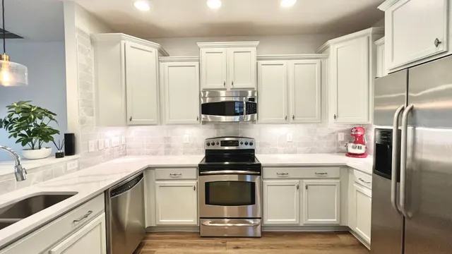 a kitchen with a sink stove and refrigerator