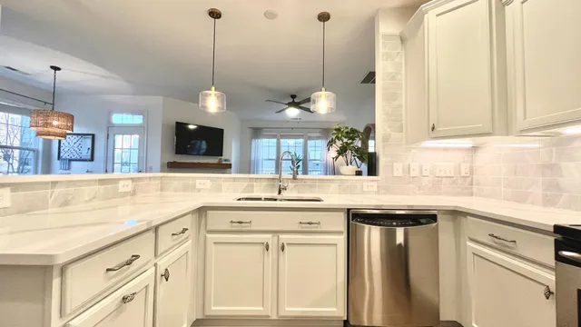 a kitchen with a sink window and cabinets