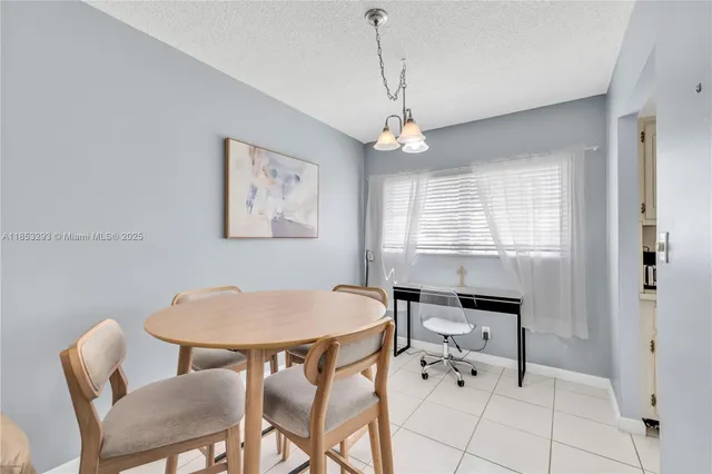 a view of a dining room with furniture and window