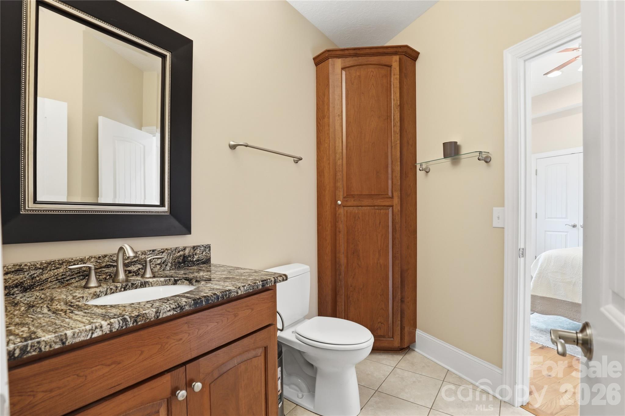 1084 Rocky Headwaters Road Moravian Falls, NC 28654 - Photo 20 of 43 a bathroom with a granite countertop sink toilet and shower