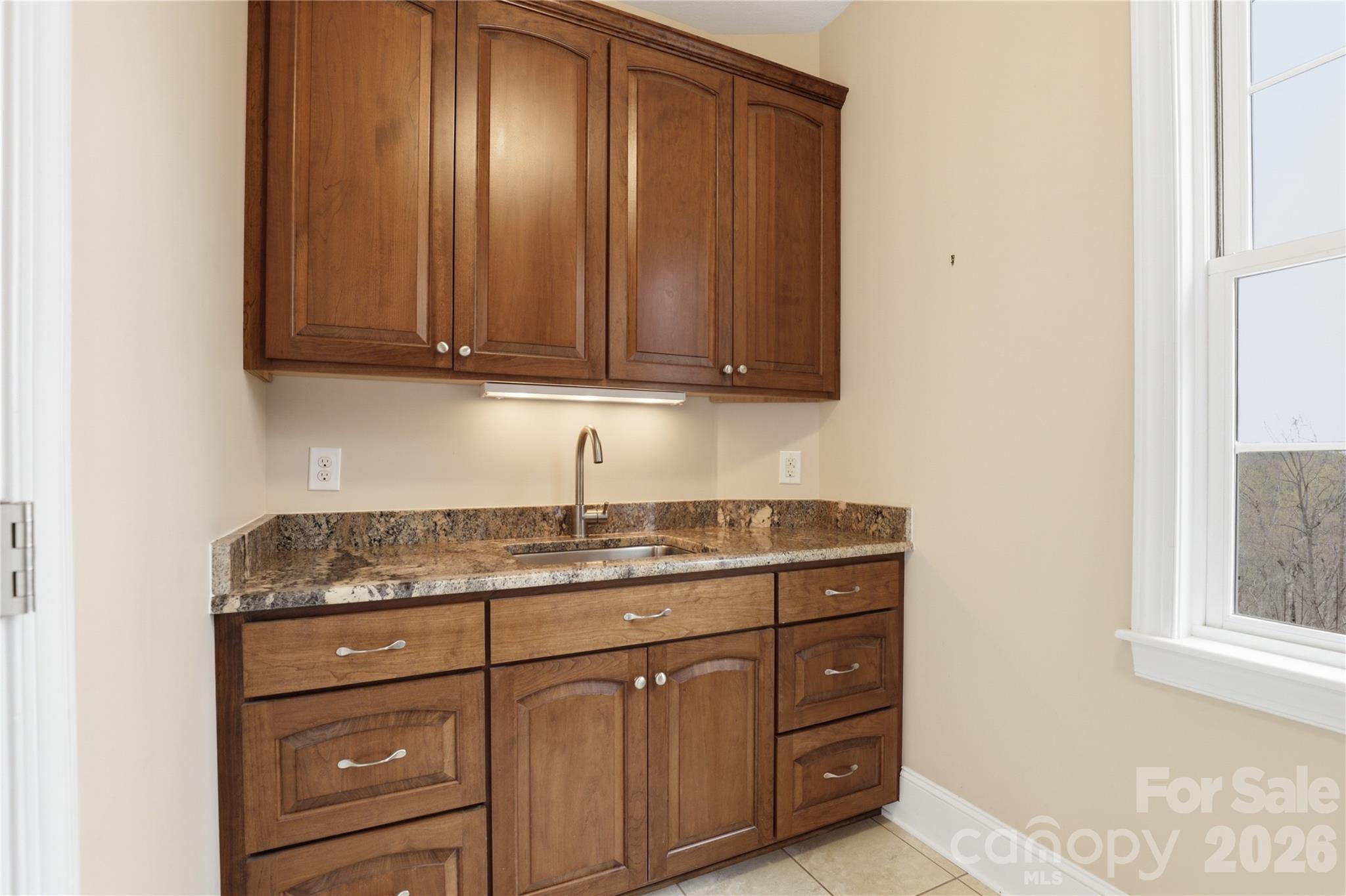 1084 Rocky Headwaters Road Moravian Falls, NC 28654 - Photo 21 of 43 a kitchen with granite countertop cabinets and window