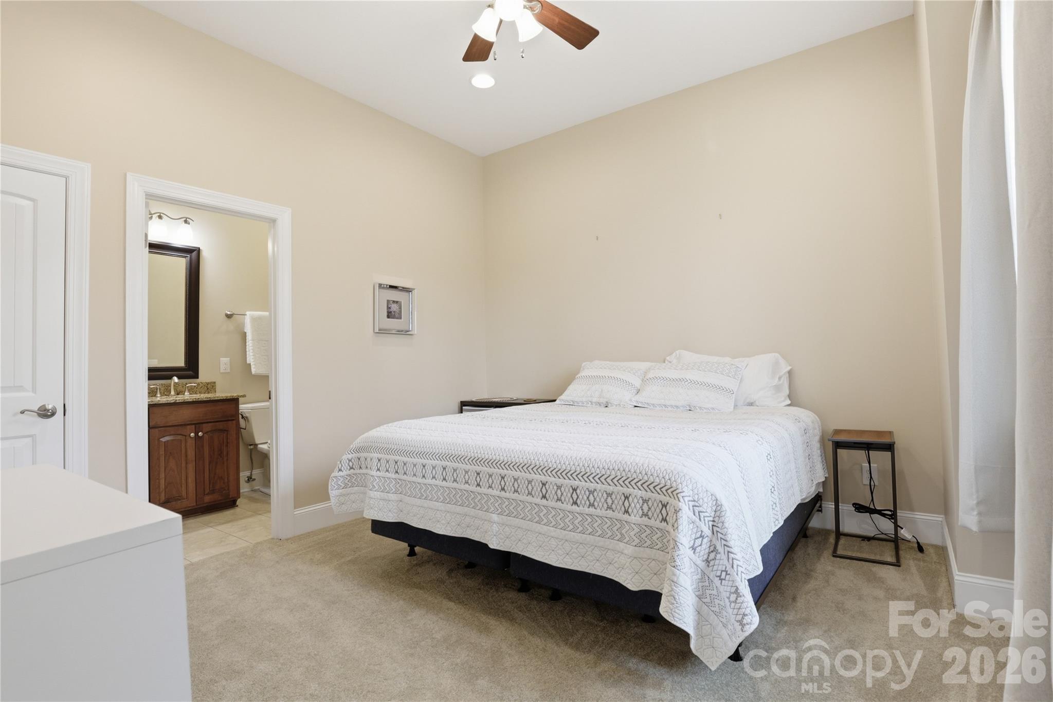 1084 Rocky Headwaters Road Moravian Falls, NC 28654 - Photo 25 of 43 a bedroom with a bed and a chandelier