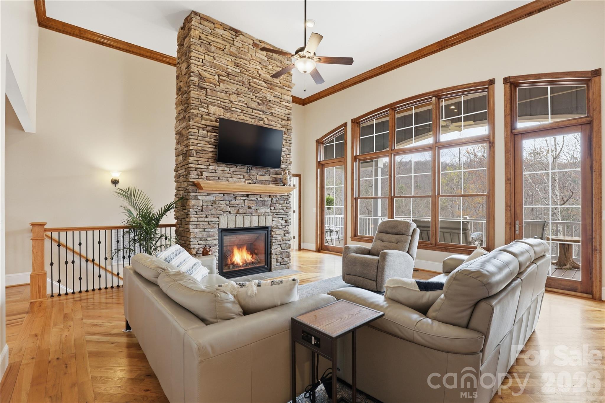 1084 Rocky Headwaters Road Moravian Falls, NC 28654 - Photo 6 of 43 a living room with furniture a flat screen tv and a fireplace