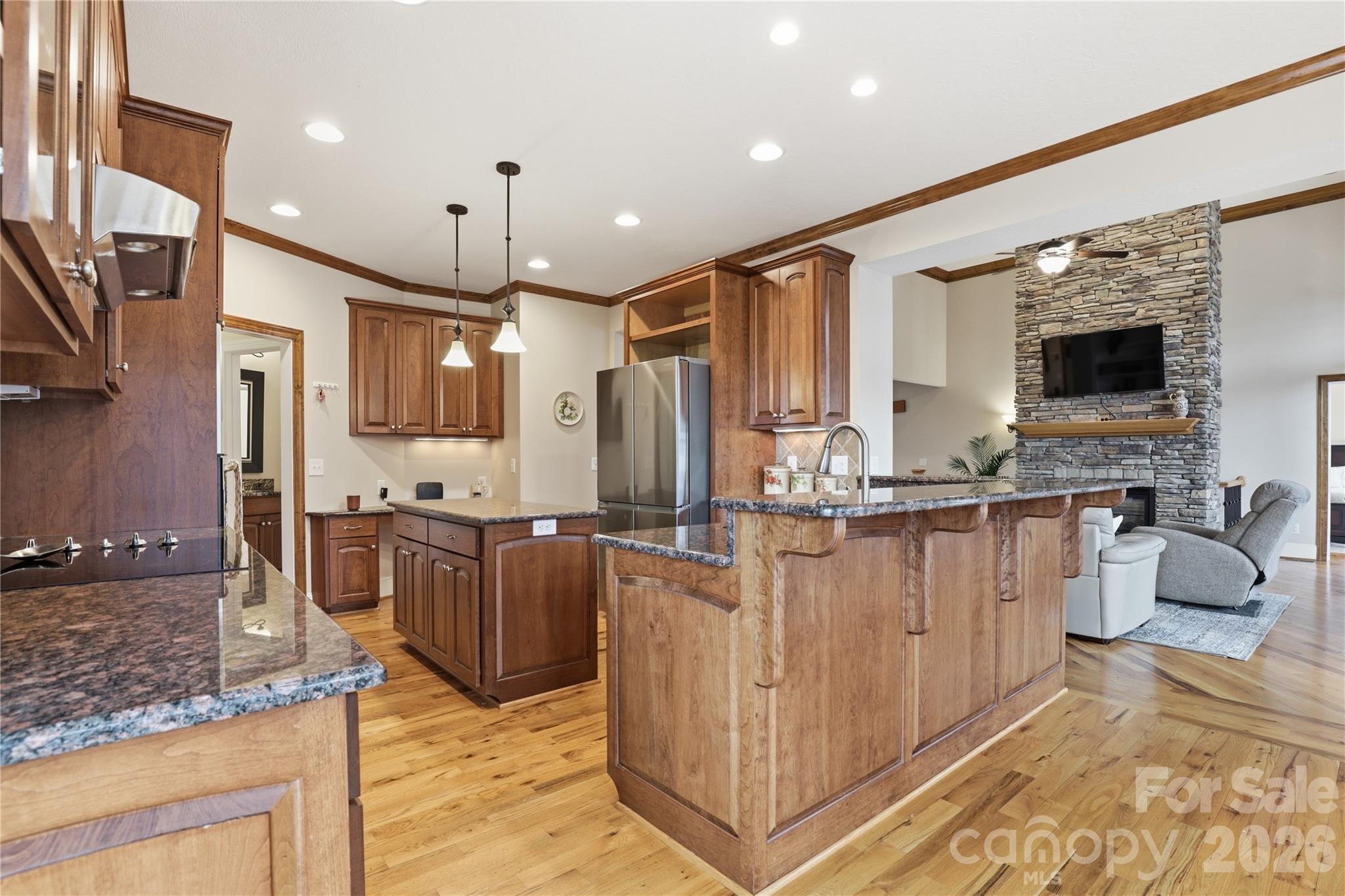 1084 Rocky Headwaters Road Moravian Falls, NC 28654 - Photo 10 of 43 a kitchen with stainless steel appliances granite countertop a refrigerator oven a sink dishwasher and white cabinets with wooden floor