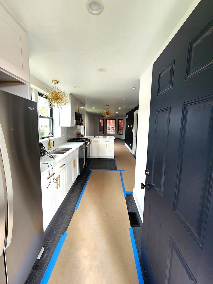 243 West Swann Street, Unit 2 Chicago, IL 60609 - Photo 2 of 10 a kitchen with stainless steel appliances granite countertop refrigerator a sink dishwasher and a stove with wooden floor