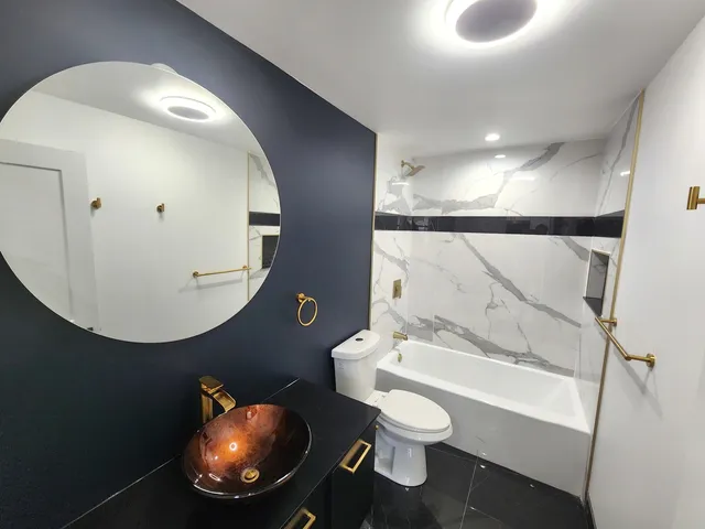 a bathroom with a sink a toilet and bathtub