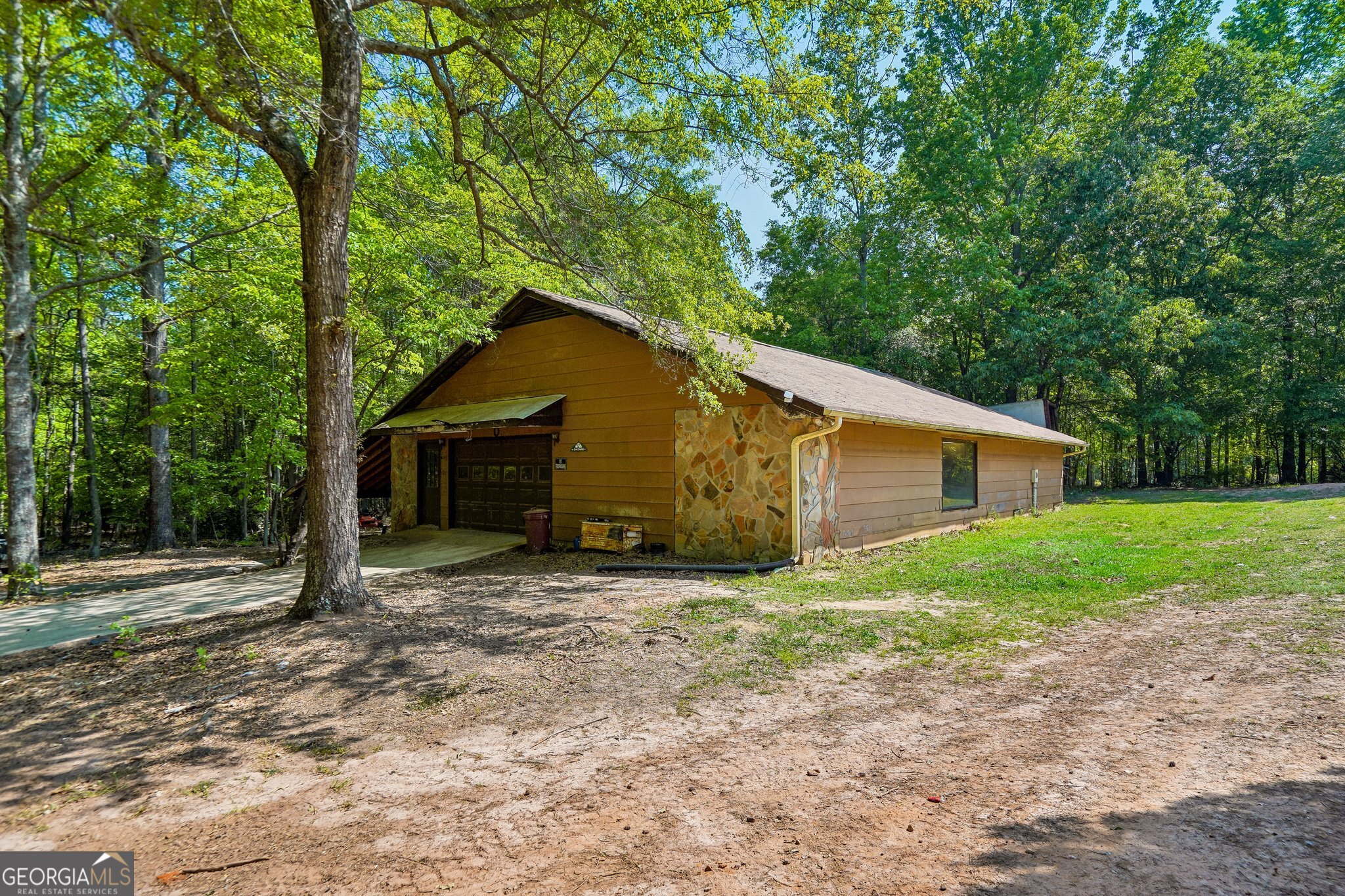241 Busbin Road Fayetteville, GA 30215 - Photo 32 of 45 a house with trees in the background