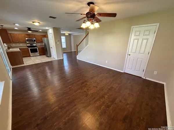 a view of a livingroom with a furniture wooden floor and a chandelier