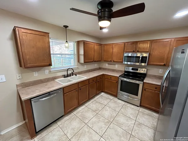 a kitchen with a sink appliances and cabinets
