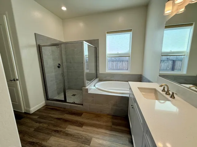 a bathroom with a tub sink and shower
