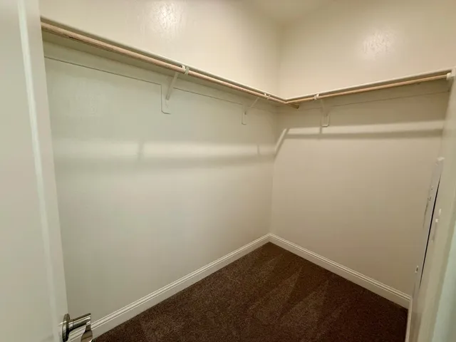 a small space with a wooden floor and a window