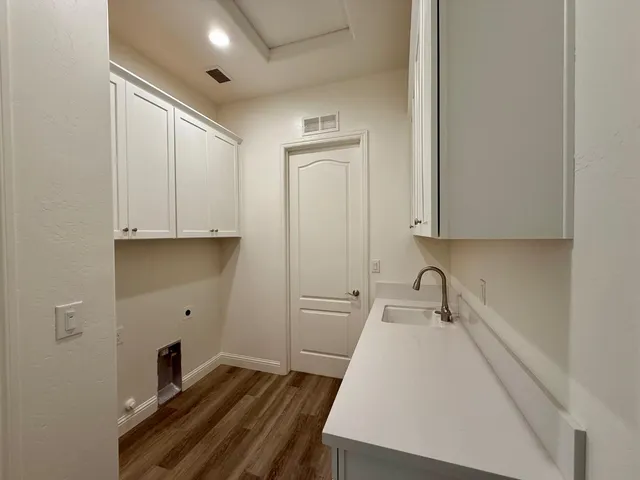 a room with a sink and cabinets