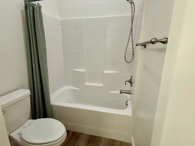 a white bath tub sitting next to a white toilet